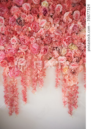 Flower garland on the wall. Dense wall of flowers Flower garland on the wall. Dense wall of flowers 39877324