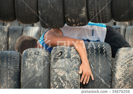 The racer overcomes the obstacle with the tire The racer overcomes the obstacle with the tire 39878208