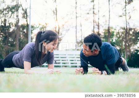 Fit sport couple doing planking. Fit sport couple doing planking. 39878856