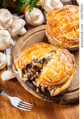 Fresh beef stew pie on a cutting board 39879684