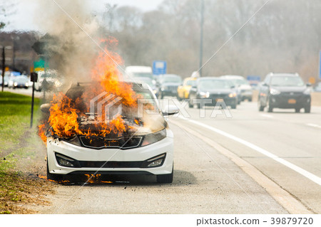 Burning car on fire on a highway road accident Burning car on fire on a highway road accident 39879720