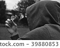 Mysterious faceless person smoking wearing a hood 39880853