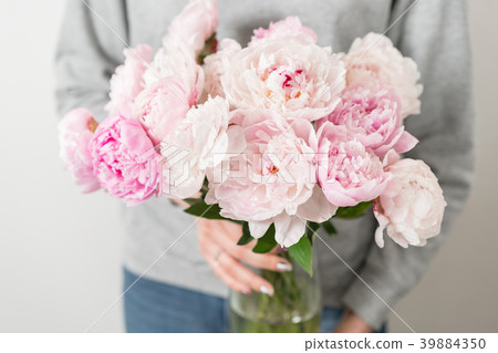 Cute and lovely peony flowers in women's hands Cute and lovely peony flowers in women's hands 39884350