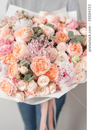 bouquet of beautiful flowers in women's hands 39884353