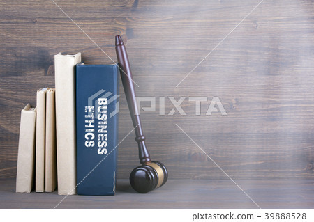 Business Ethics. Wooden gavel and books in background. Law and justice concept Business Ethics. Wooden gavel and books in background. Law and justice concept 39888528
