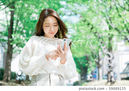 A young woman operating a smartphone A young woman operating a smartphone 39889135
