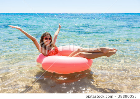 Crazy swimming with inflatable donut on the beach 39890053