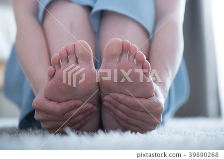 A young Japanese woman doing a foot massage A young Japanese woman doing a foot massage 39890268