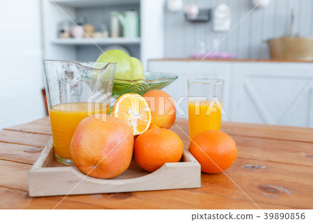 Still life: oranges and glass of juice on a wooden Still life: oranges and glass of juice on a wooden 39890856