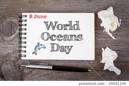 8 june World Oceans Day. Notebook and pen on the old wooden table 8 june World Oceans Day. Notebook and pen on the old wooden table 39891249