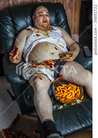 Fat man eating junk food and watching television Fat man eating junk food and watching television 39891722