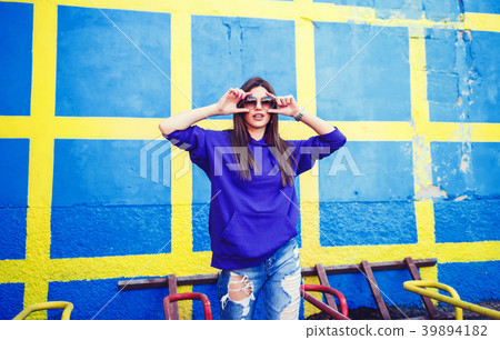 woman with long hair in jeans and sunglasses woman with long hair in jeans and sunglasses 39894182