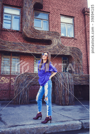 fashion girl standing near a brick wall fashion girl standing near a brick wall 39894185