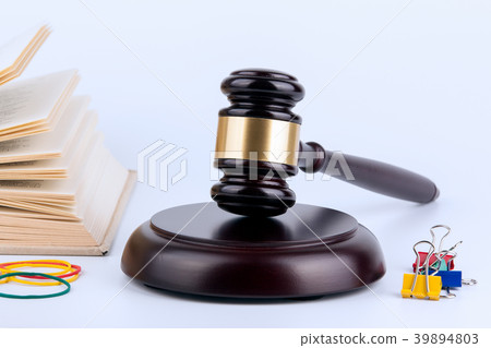 Wooden gavel and books in background. Law and justice concept Wooden gavel and books in background. Law and justice concept 39894803