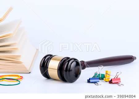 Wooden gavel and books in background. Law and justice concept Wooden gavel and books in background. Law and justice concept 39894804