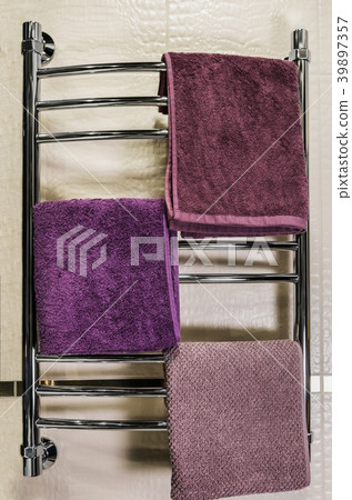 towels of different colors are hung on a heated towels of different colors are hung on a heated 39897357