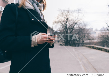 Smiling attractive young woman in coat Smiling attractive young woman in coat 39898649
