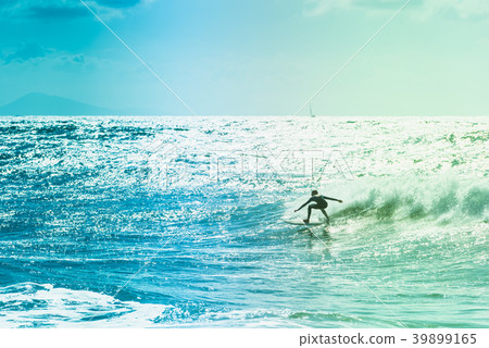 Surfers riding some waves on the sea Surfers riding some waves on the sea 39899165