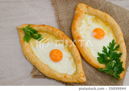 Top view of two khachapuri on a light table Top view of two khachapuri on a light table 39899944