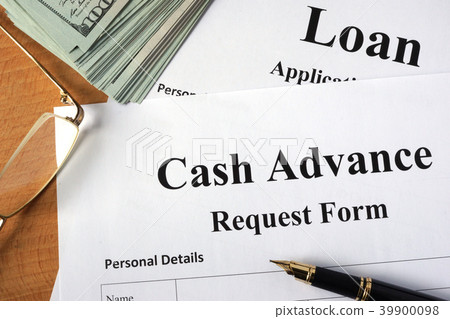 Cash advance form on a wooden table. Cash advance form on a wooden table. 39900098