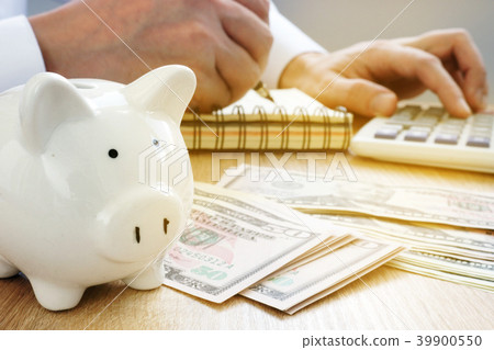Man writing in an accounting book. Savings concept Man writing in an accounting book. Savings concept 39900550