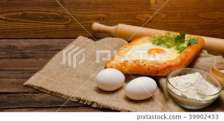Khachapuri with eggs on sackcloth, flour and eggs 39902433
