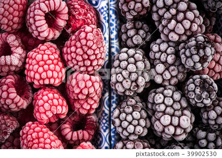 Frozen blackberry and raspberry fruits, close up Frozen blackberry and raspberry fruits, close up 39902530