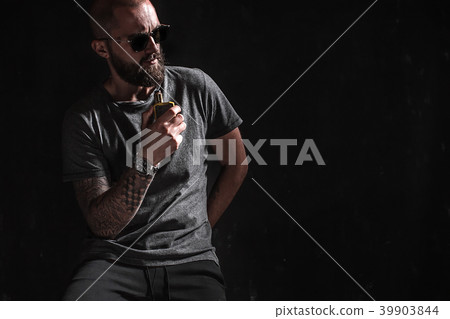Men with beard in sunglasses vaping. Men with beard in sunglasses vaping. 39903844