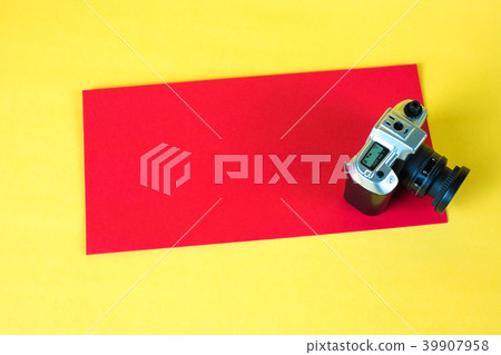 Mini camera toy and red envelop on yellow Mini camera toy and red envelop on yellow 39907958
