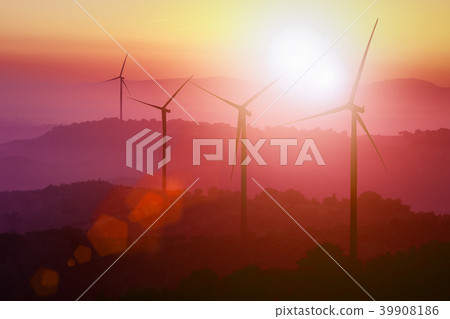 Wind turbines silhouette on mountains at sunset. 39908186