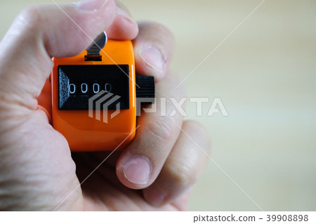 Hand holding tally counter or counting machine Hand holding tally counter or counting machine 39908898