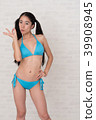 A woman wearing a bikini has various poses and expressions in front of a white background. 39908945