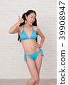 A woman wearing a bikini has various poses and expressions in front of a white background. 39908947