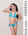 A woman wearing a bikini has various poses and expressions in front of a white background. 39908951