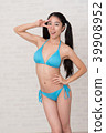 A woman wearing a bikini has various poses and expressions in front of a white background. 39908952