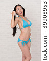 A woman wearing a bikini has various poses and expressions in front of a white background. 39908953