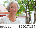 Older Asian women with grayish hair have smiling 39917185