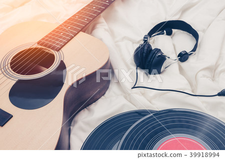acoustic guitar, record & headphone on white bed acoustic guitar, record & headphone on white bed 39918994