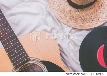 acoustic guitar, record & hat on white bed acoustic guitar, record & hat on white bed 39918995