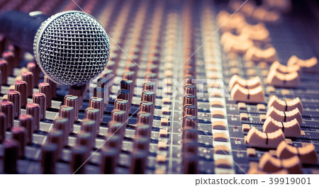 dynamic microphone on audio mixing board 39919001