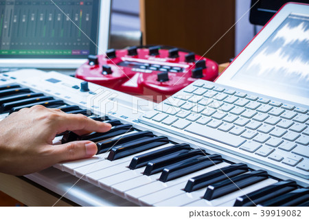 composer hands working on sound studio equipments composer hands working on sound studio equipments 39919082