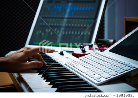 composer hands working on sound studio equipments composer hands working on sound studio equipments 39919083