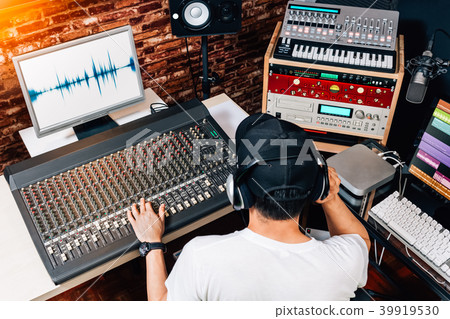 male sound engineer working in recording studio 39919530