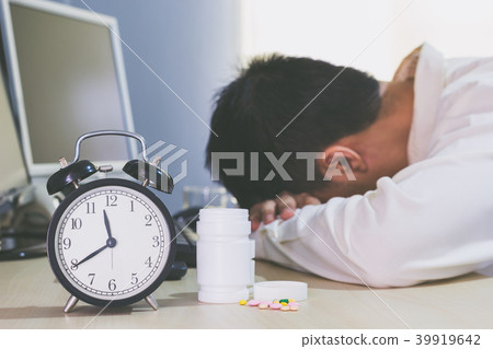 tired & sick asian businessman work overtime 39919642