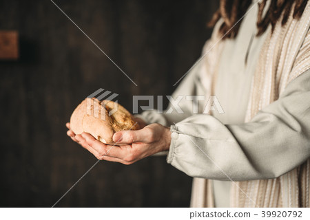 Jesus Christ with bread in hands, sacred food 39920792