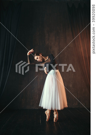 Classical ballet dancer in motion on the stage 39920898