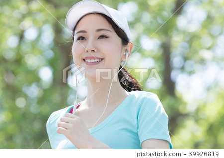 A young Japanese woman who runs while listening to music A young Japanese woman who runs while listening to music 39926819
