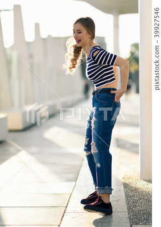 Funny blonde woman laughing in urban background. Funny blonde woman laughing in urban background. 39927546