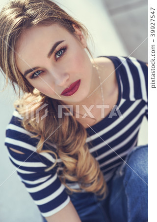 Blonde woman, model of fashion, possing in urban background. Blonde woman, model of fashion, possing in urban background. 39927547