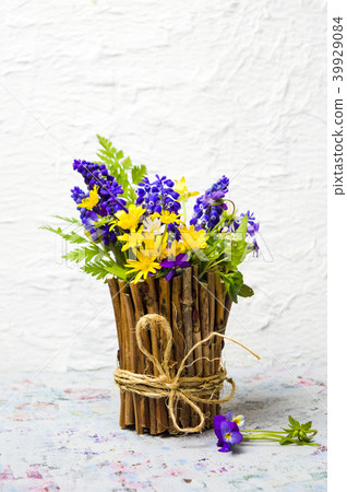 Colorful spring flowers in a rustic vase 39929084